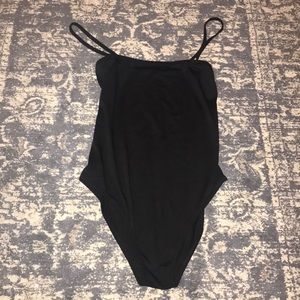 A black one-piece (a shirt not bathing suite)